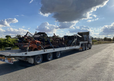 Large Tilt tray truck transporting heavy machinery on the Fleurieu Peninsula